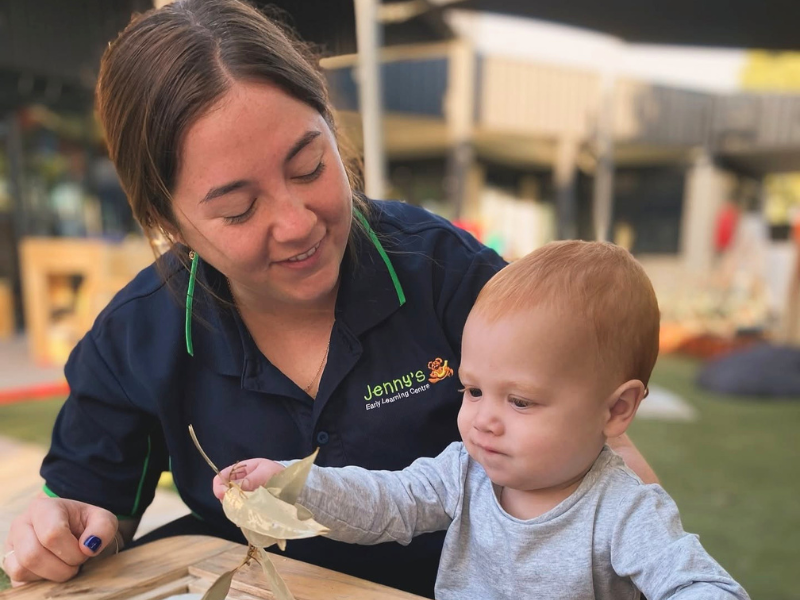 Educator with a young child