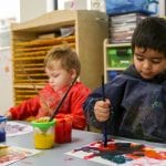 Jenny's ELC Maiden Gully kids painting in smocks